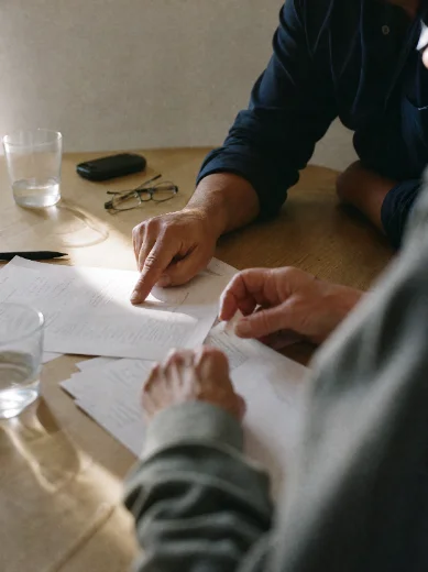 Two people reviewing a treatment plan at a table.