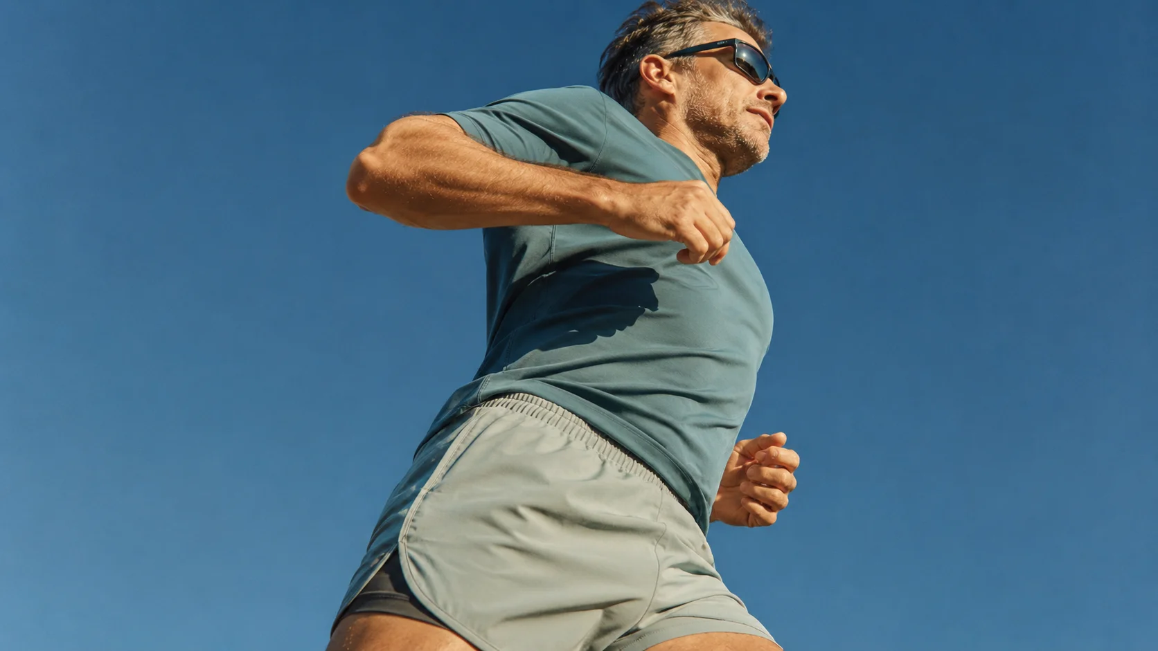 Runner against a blue sky.